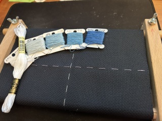 Colors of thread against the fabric for Upon A Star cross stitch project